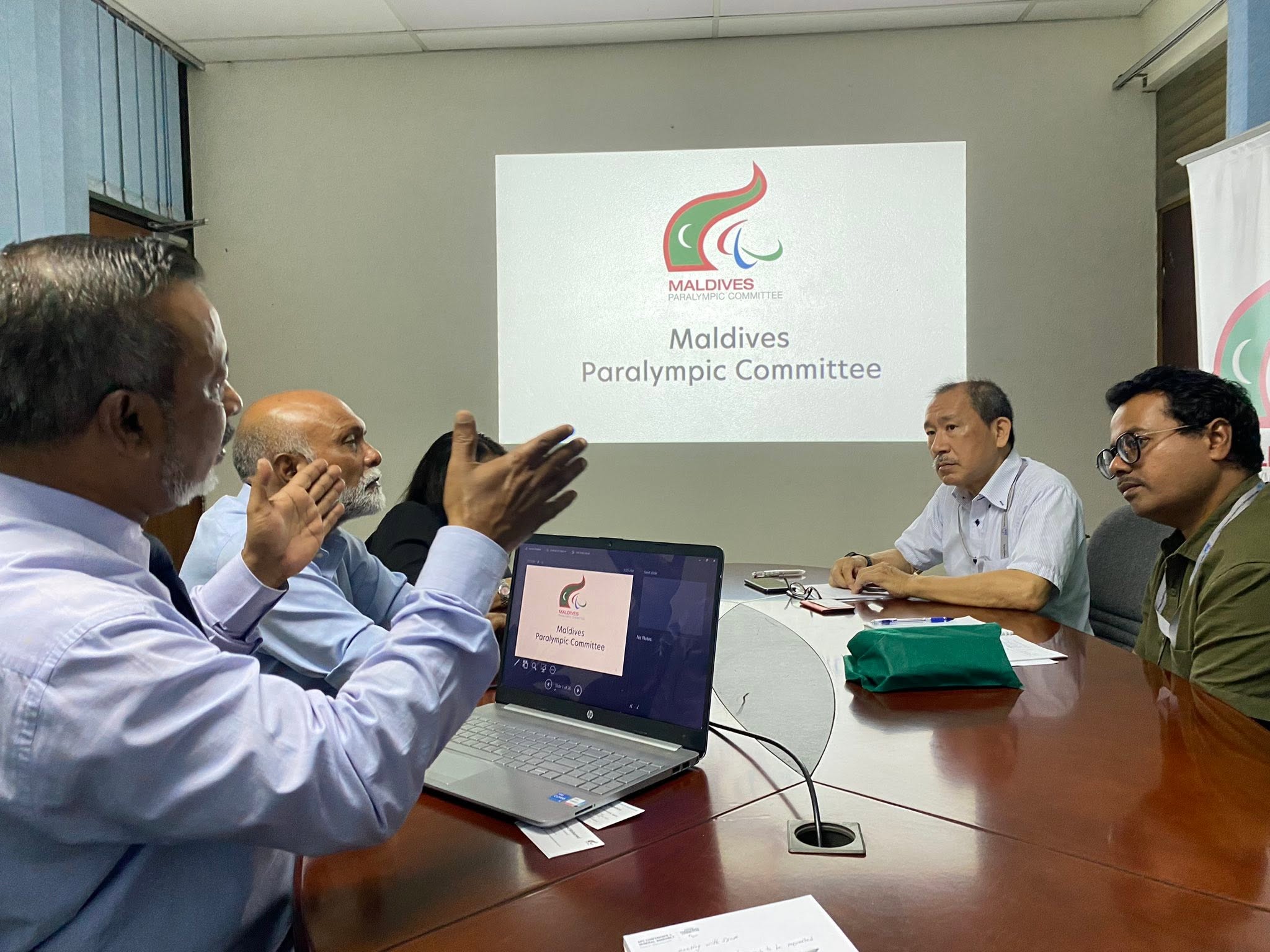 MPC and JICA representatives discuss their partnership around a meeting table.