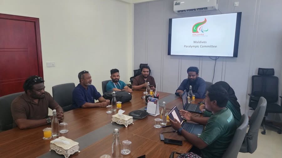 MPC and Naifaru Council representatives meet around a conference table.